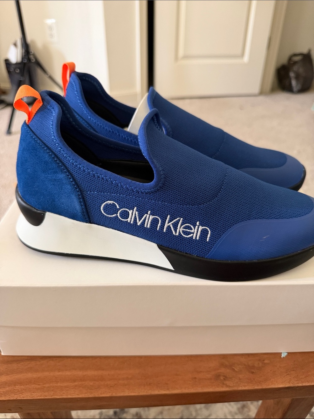 Calvin Klein Women’s Slip-On Athletic Sneakers in Blue with Orange Accent